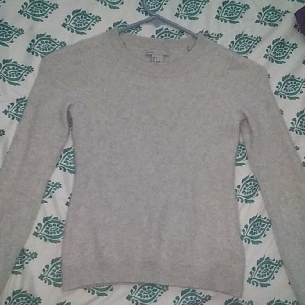 A long sleeve grey sweater.